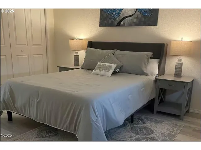 a bedroom with a bed and a night stand
