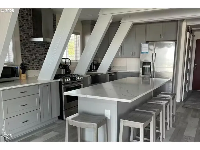 a kitchen with a table chairs and a refrigerator