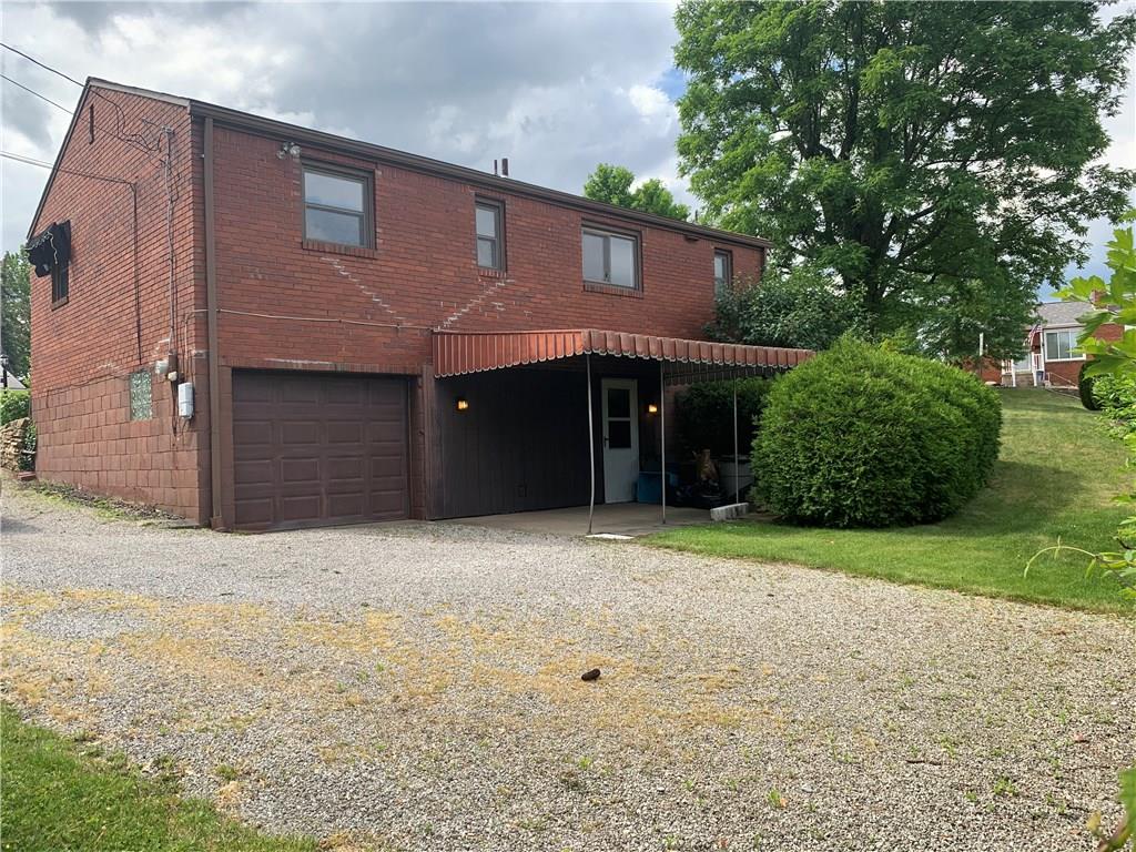 4227 Greenridge Road Pittsburgh, PA 15234 - Photo 17 of 23 Brick ranch on corner lot with spacious yard. Gravel driveway and integrated rear-entry garage. Private back patio perfect for grilling or relaxing.