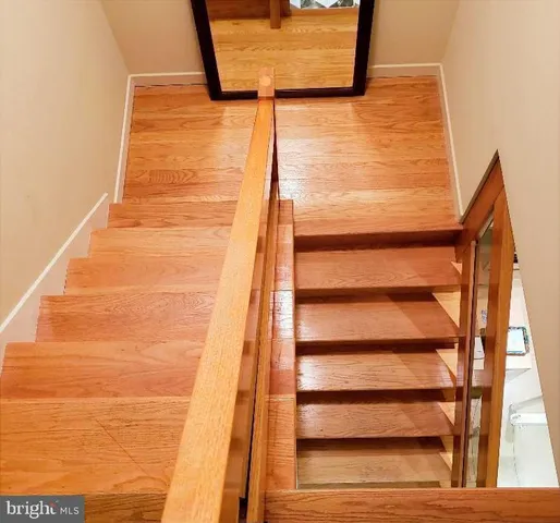 a bathroom with a granite countertop shower and a toilet
