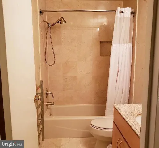 a bathroom with a sink vanity mirror and toilet