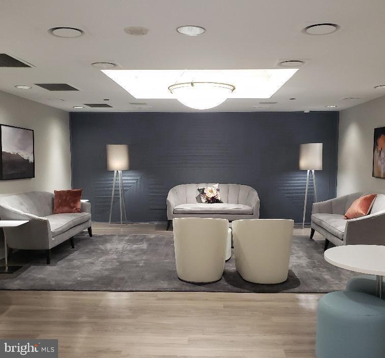 1530 Key Boulevard, Unit 1319 Arlington, VA 22209 - Photo 24 of 30 a living room with a couch and a flat screen tv