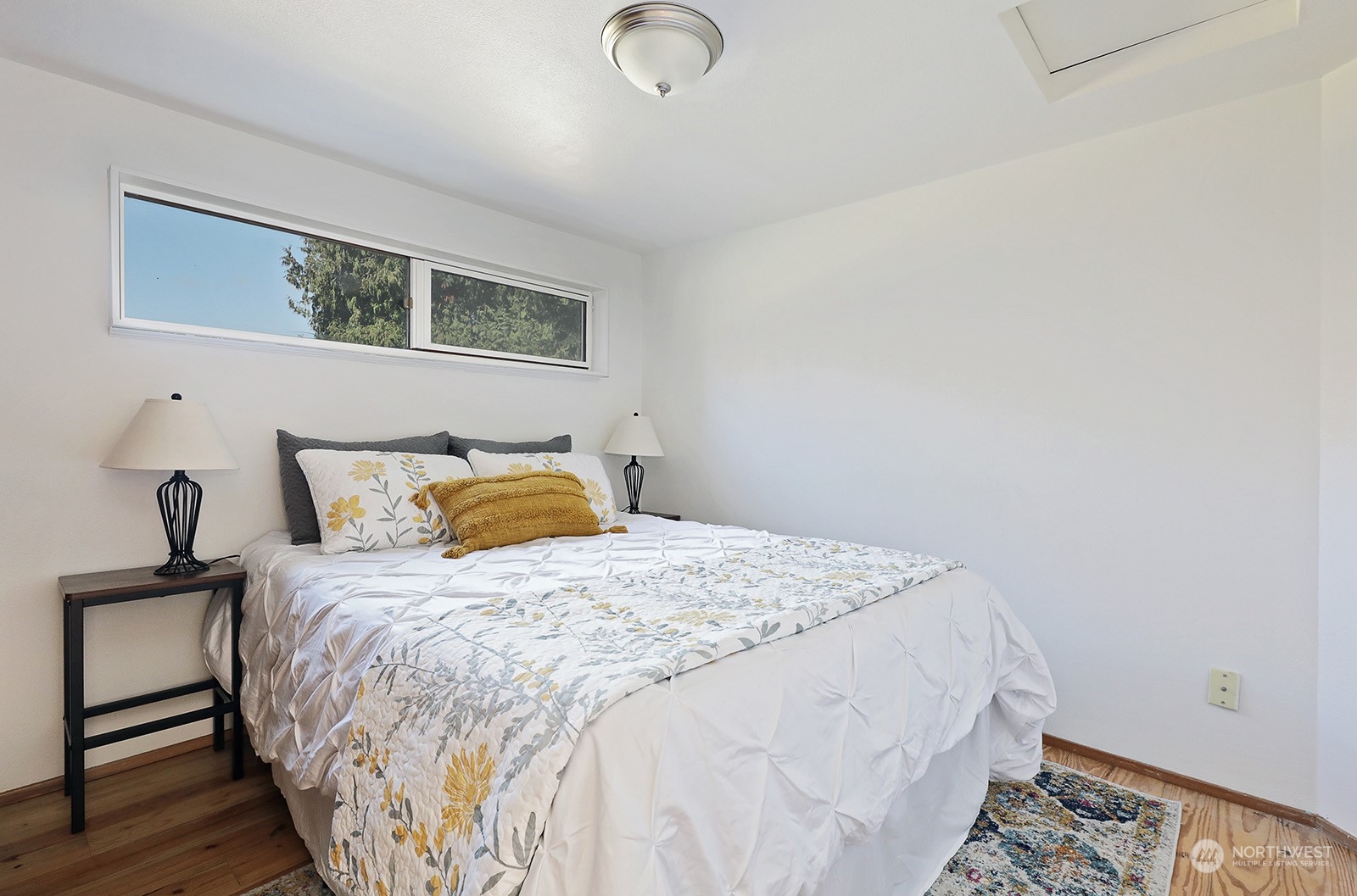 5612 Osprey Road Freeland, WA 98249 - Photo 14 of 29 a bedroom with a bed and wooden floor