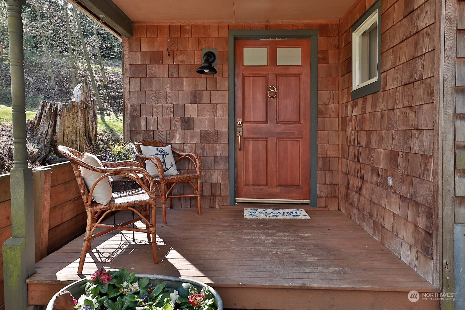 5612 Osprey Road Freeland, WA 98249 - Photo 5 of 29 a view of a patio with table and chairs with barbeque grill and wooden fence