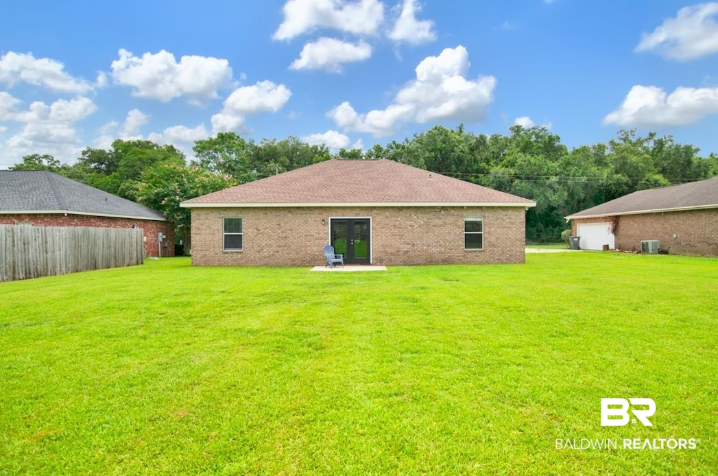 27545 Boaz Road West Loxley, AL 36551 - Photo 22 of 26 Back of house featuring a garage, brick siding, and french doors