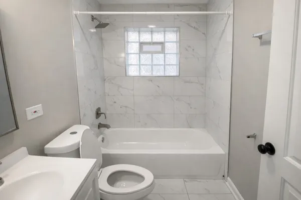 a bathroom with a toilet and a bathtub