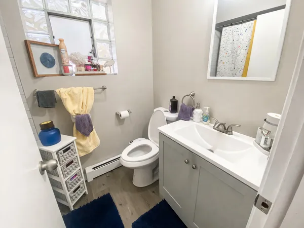 a bathroom with a toilet sink and mirror