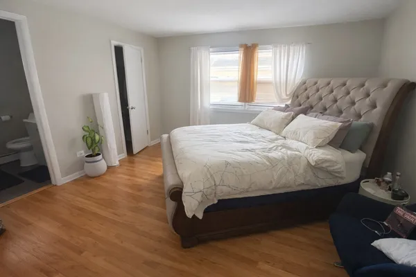 a bed sitting in a bedroom next to a window