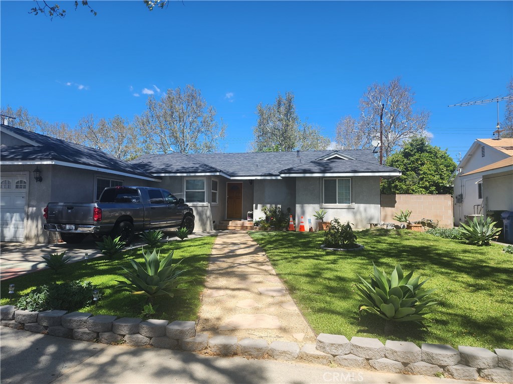 4151 Deborah Street Simi Valley, CA 93063 - Photo 1 of 1 a front view of a house with a yard table and chairs