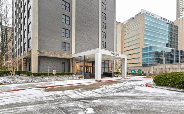 a lobby with furniture and potted plants