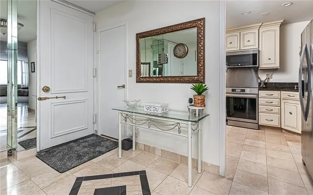 a bathroom with a granite countertop sink a toilet and a mirror