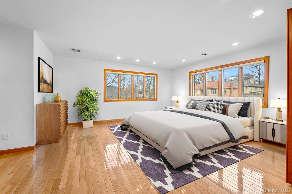 64-16 211th Street Queens, NY 11364 - Photo 11 of 22 a spacious bedroom with a large bed and a large window