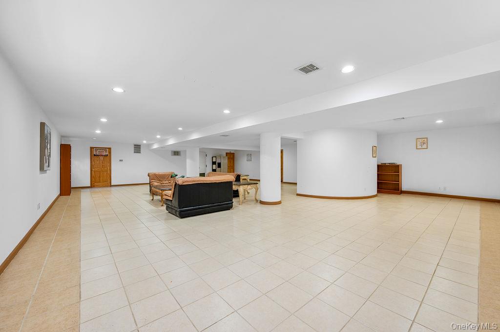 64-16 211th Street Queens, NY 11364 - Photo 12 of 22 a large room with a large window and furniture