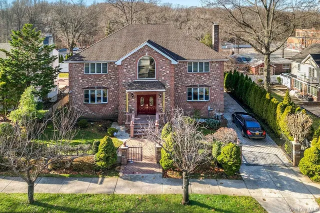 a aerial view of a house with yard and green space