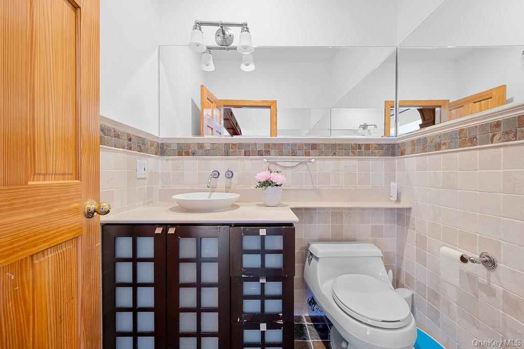 64-16 211th Street Queens, NY 11364 - Photo 8 of 22 a bathroom with a sink and a toilet