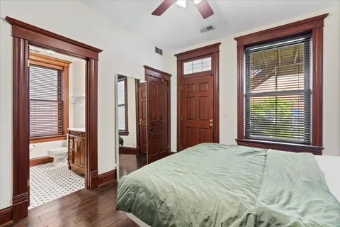 a bedroom with a bed and a large window