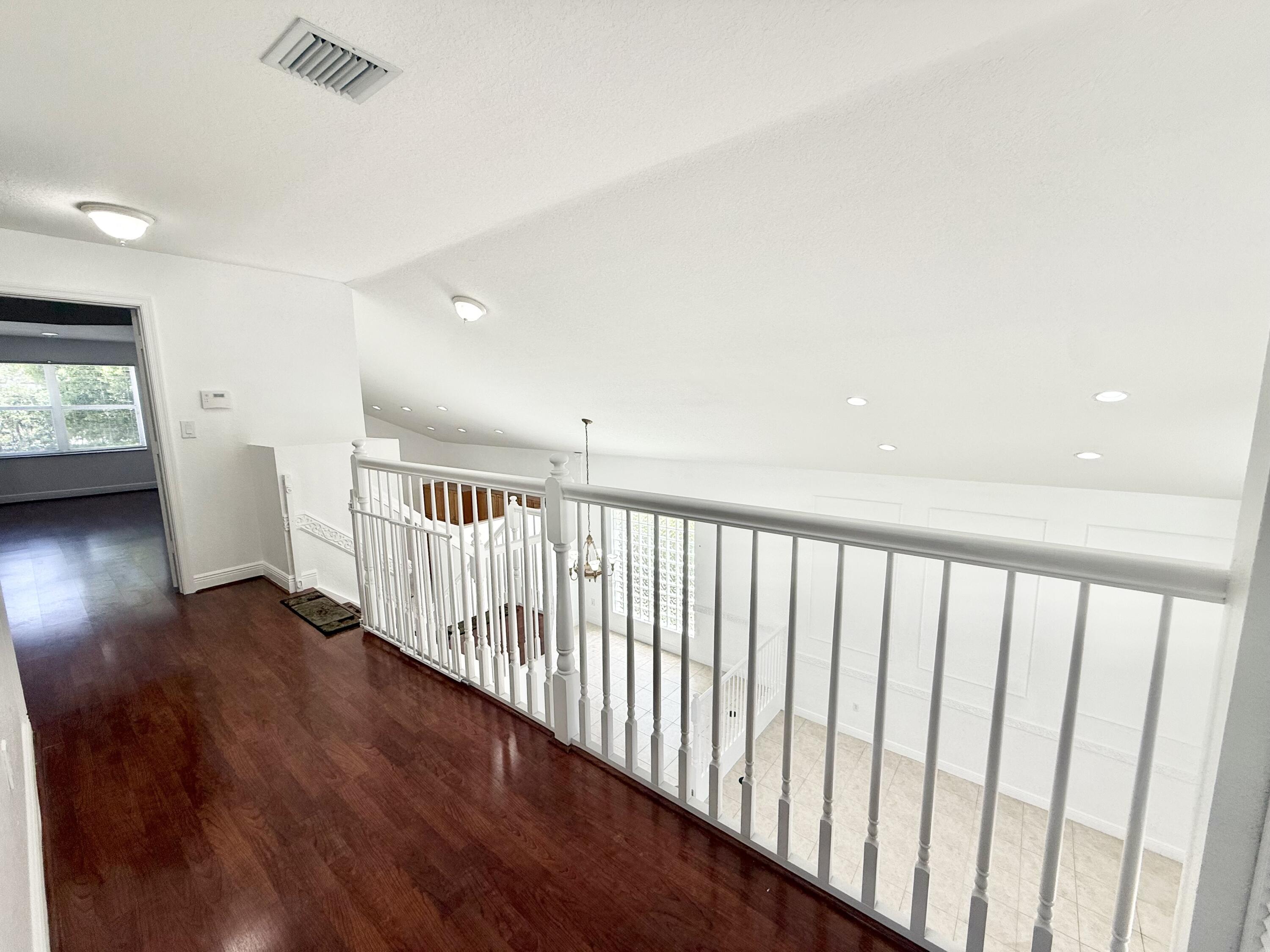 11553 Big Sky Court Boca Raton, FL 33498 - Photo 13 of 43 a view of staircase with wooden floor