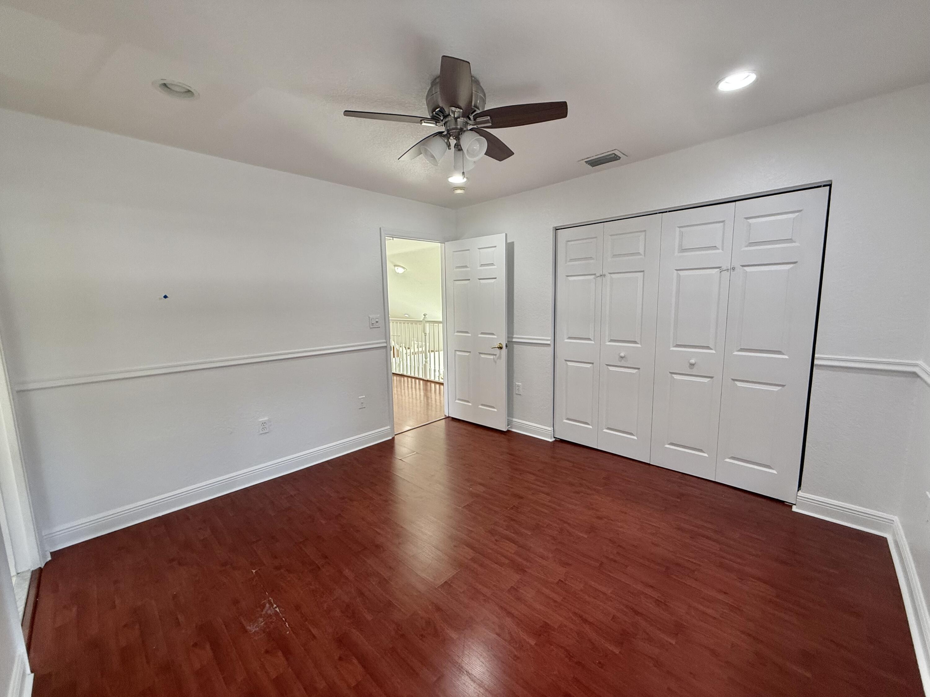 11553 Big Sky Court Boca Raton, FL 33498 - Photo 16 of 43 wooden floor in an empty room with a window