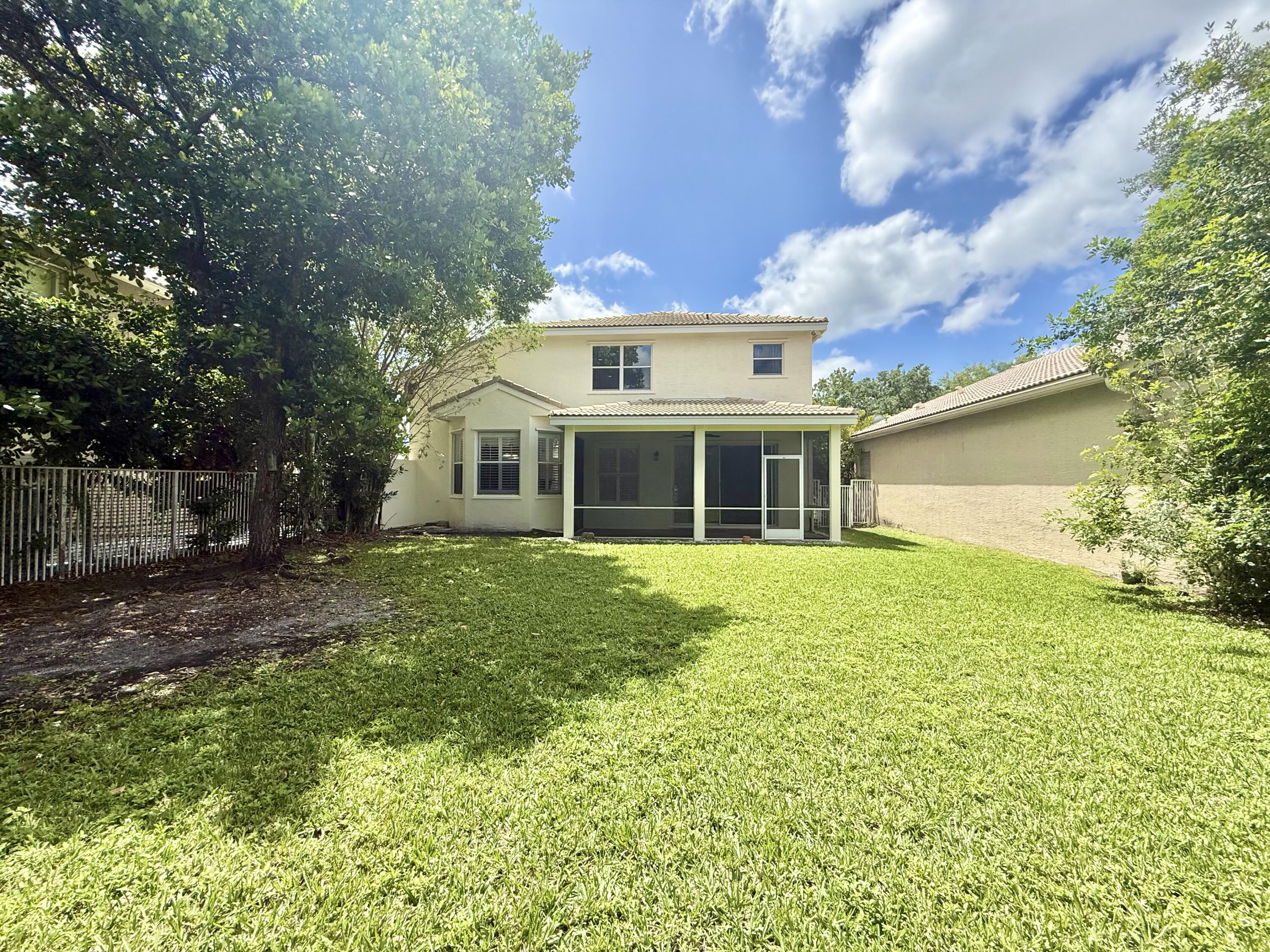 11553 Big Sky Court Boca Raton, FL 33498 - Photo 2 of 43 a front view of a house with a garden