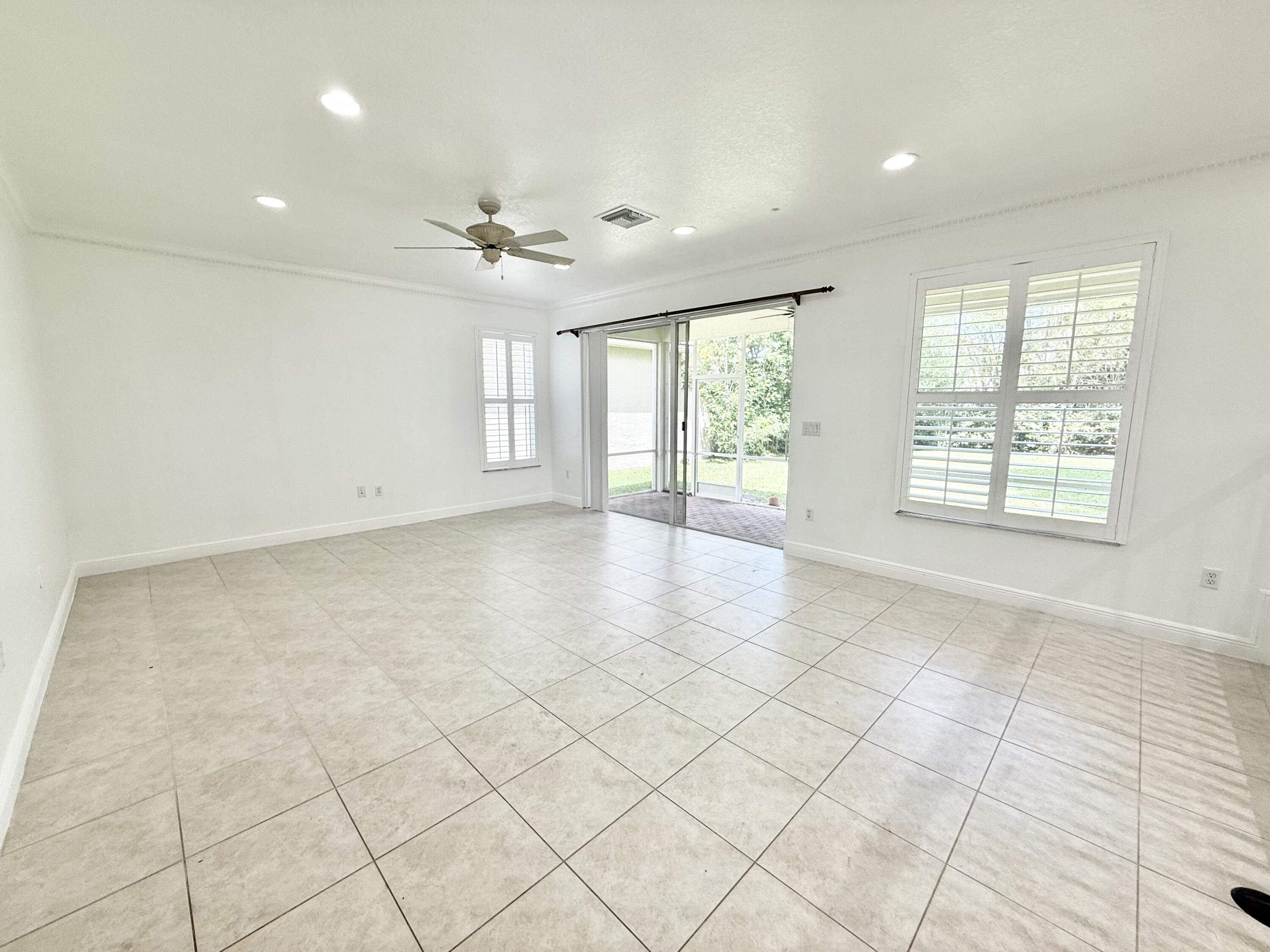 11553 Big Sky Court Boca Raton, FL 33498 - Photo 24 of 43 an empty room with windows and chandelier fan