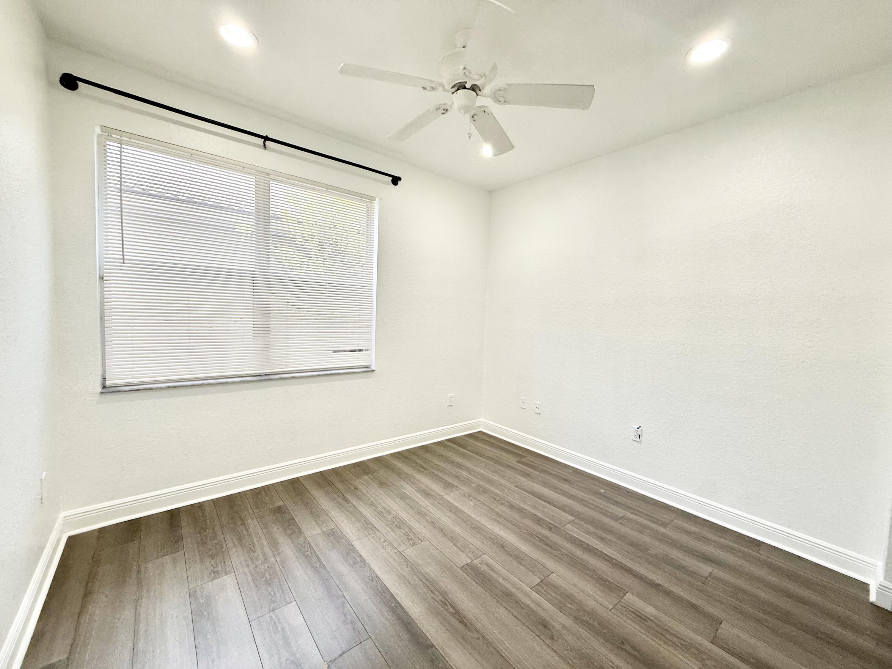 11553 Big Sky Court Boca Raton, FL 33498 - Photo 25 of 43 an empty room with a window and a ceiling fan