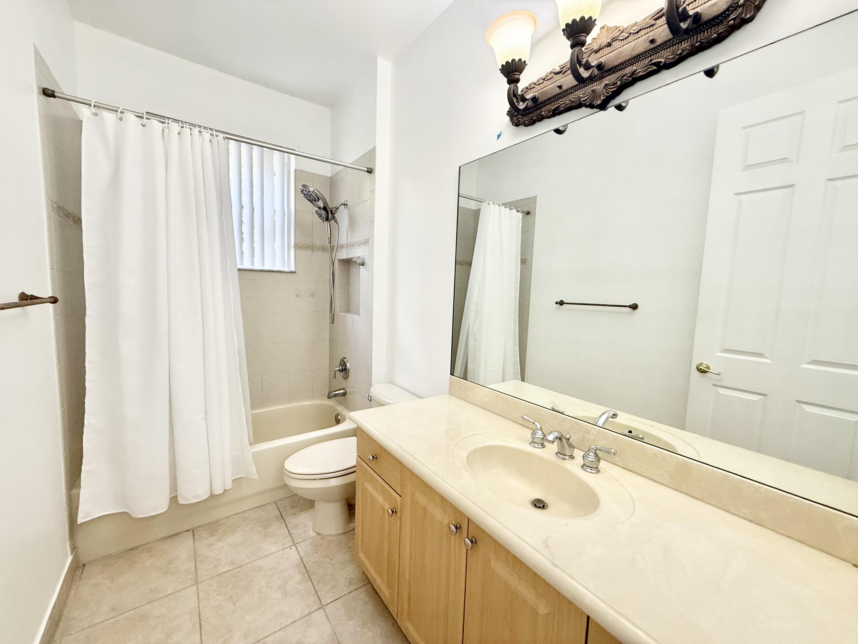 11553 Big Sky Court Boca Raton, FL 33498 - Photo 26 of 43 a bathroom with a double vanity sink toilet and shower