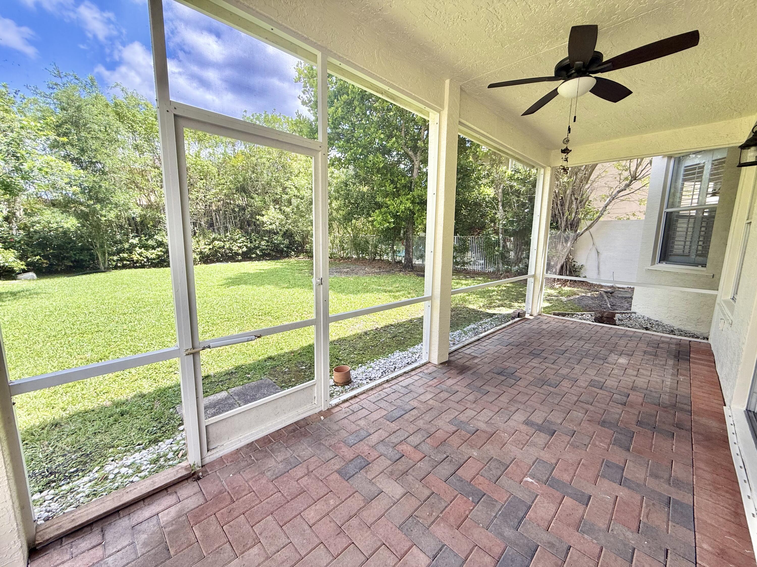 11553 Big Sky Court Boca Raton, FL 33498 - Photo 27 of 43 a view of porch with a floor to ceiling window and a yard