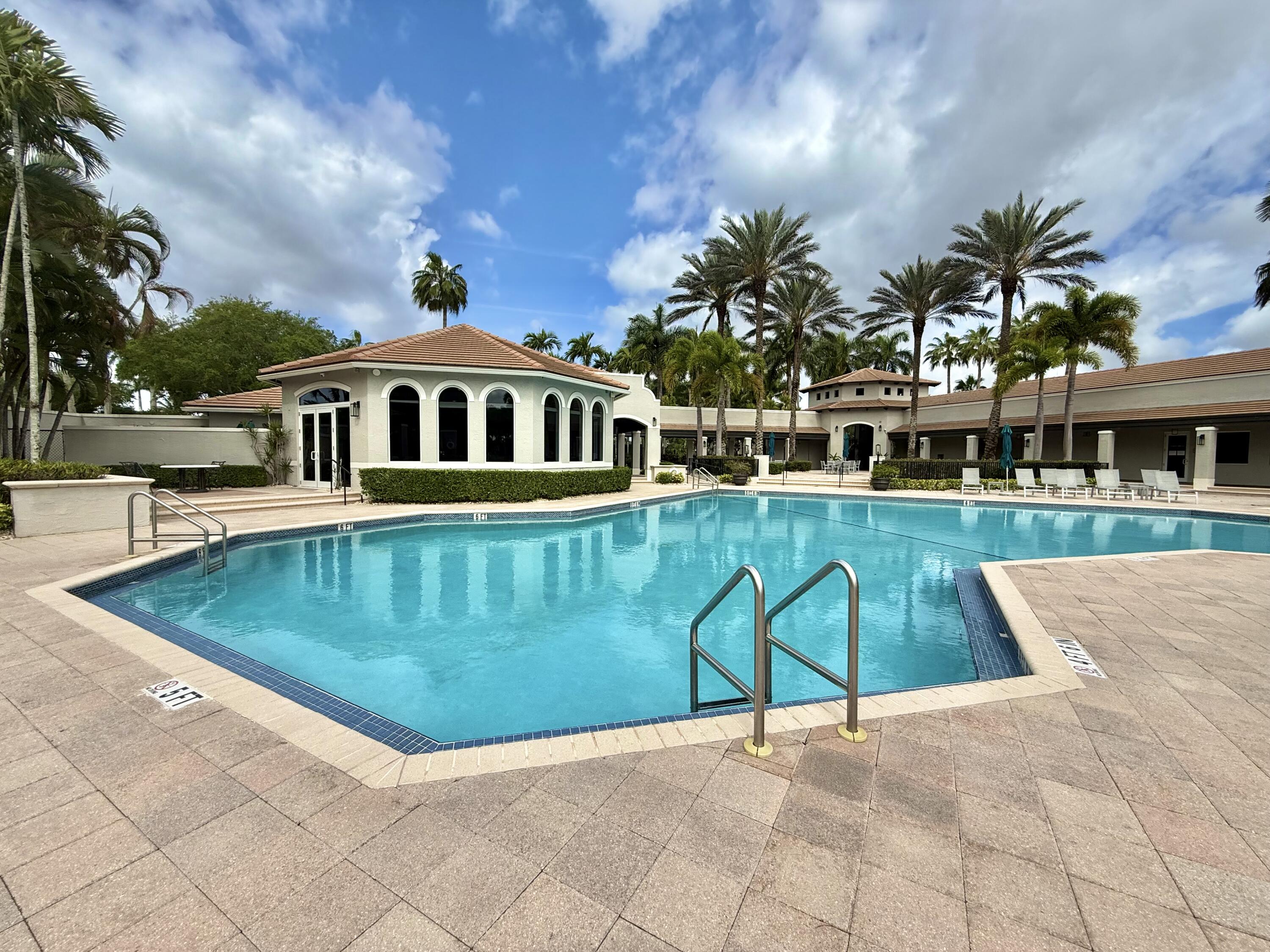 11553 Big Sky Court Boca Raton, FL 33498 - Photo 33 of 43 a view of a swimming pool with a garden