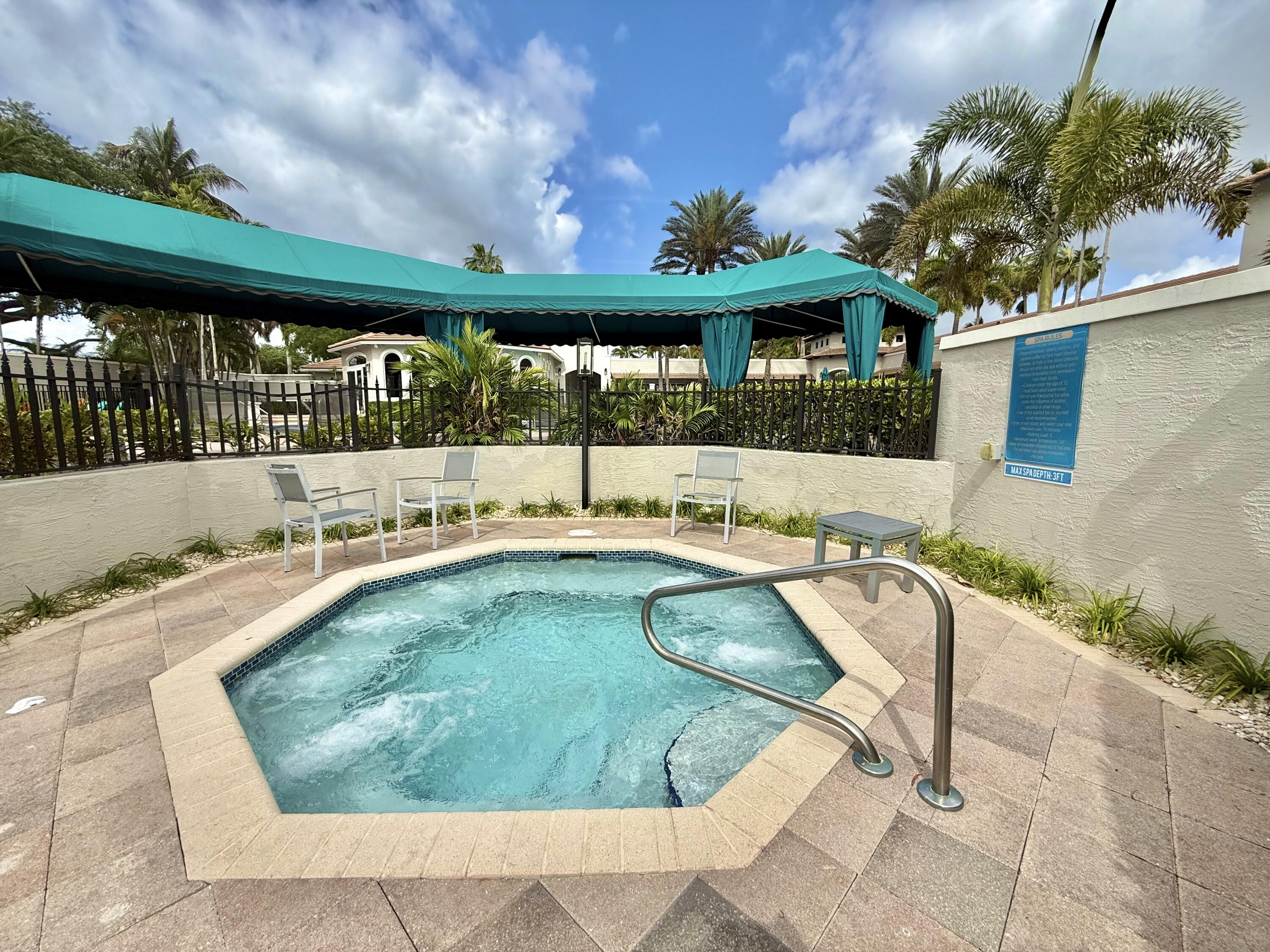 11553 Big Sky Court Boca Raton, FL 33498 - Photo 34 of 43 a view of a swimming pool with a patio