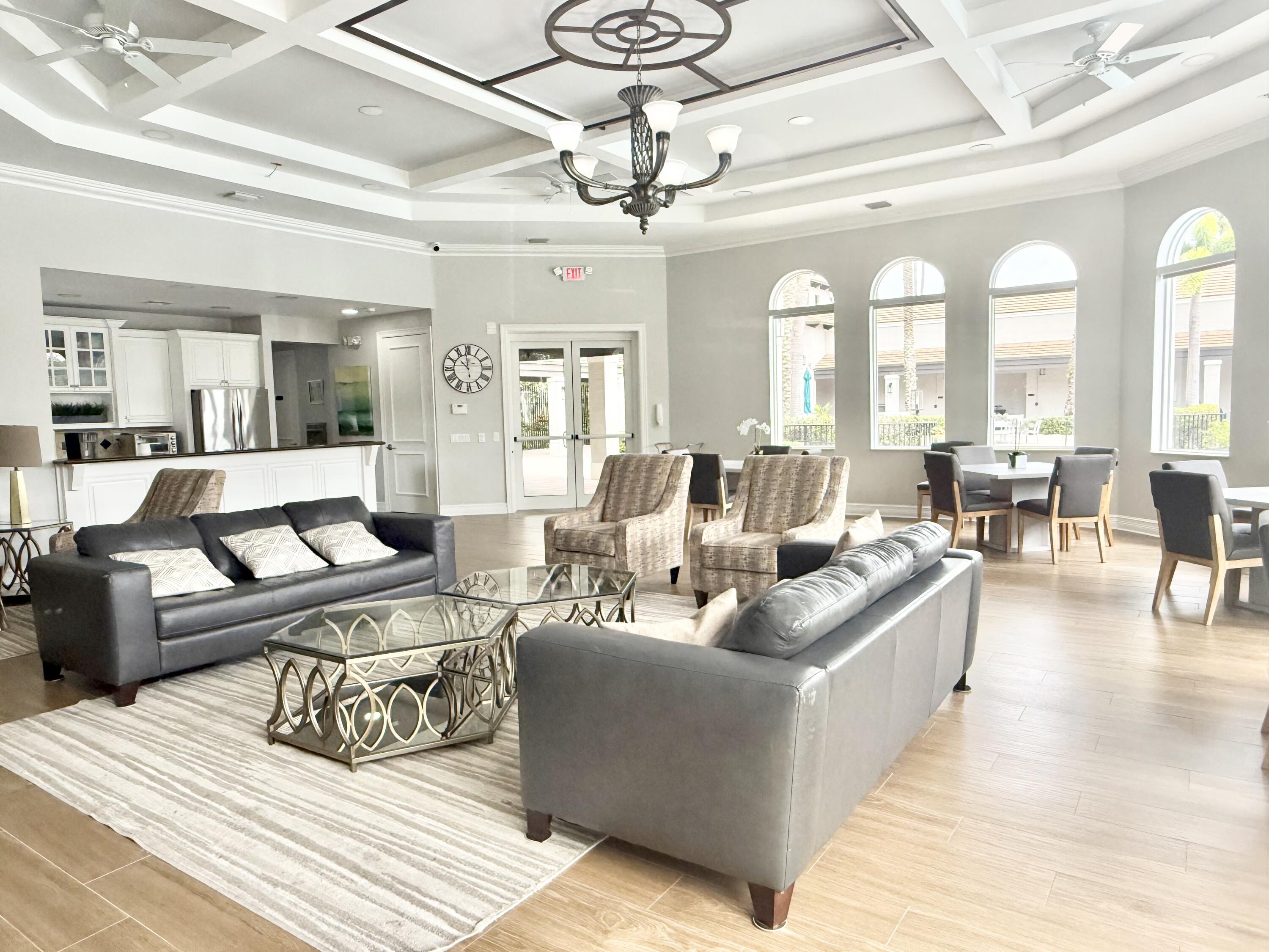 11553 Big Sky Court Boca Raton, FL 33498 - Photo 36 of 43 a living room with furniture and a chandelier