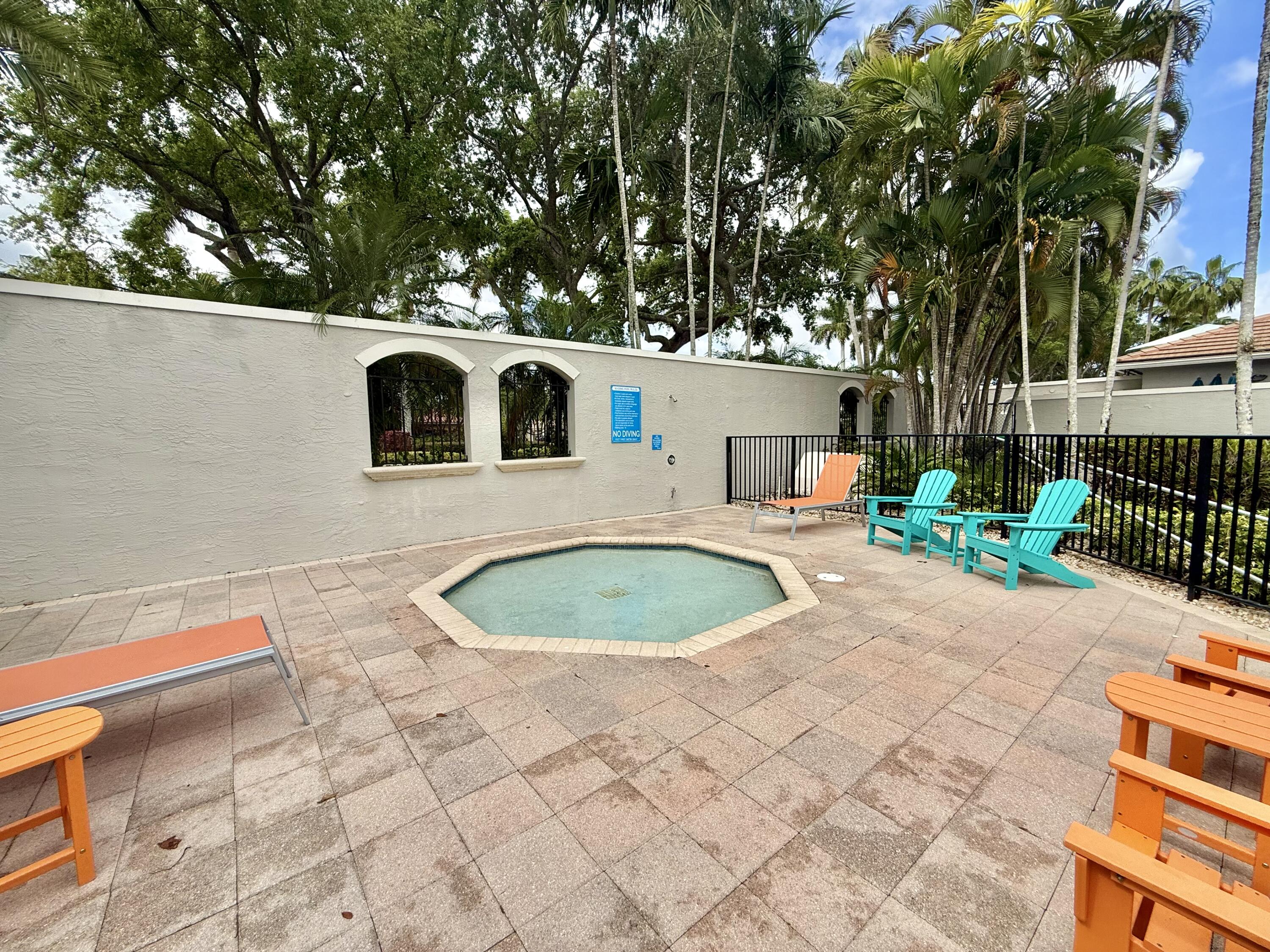 11553 Big Sky Court Boca Raton, FL 33498 - Photo 41 of 43 a white house with a small yard and large trees