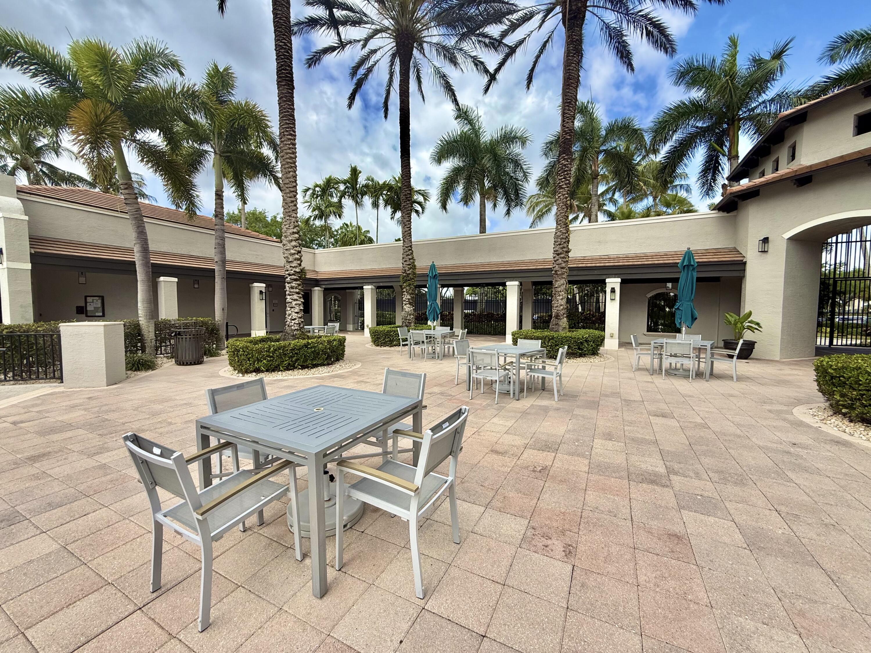 11553 Big Sky Court Boca Raton, FL 33498 - Photo 42 of 43 a view of a patio with a table and chairs