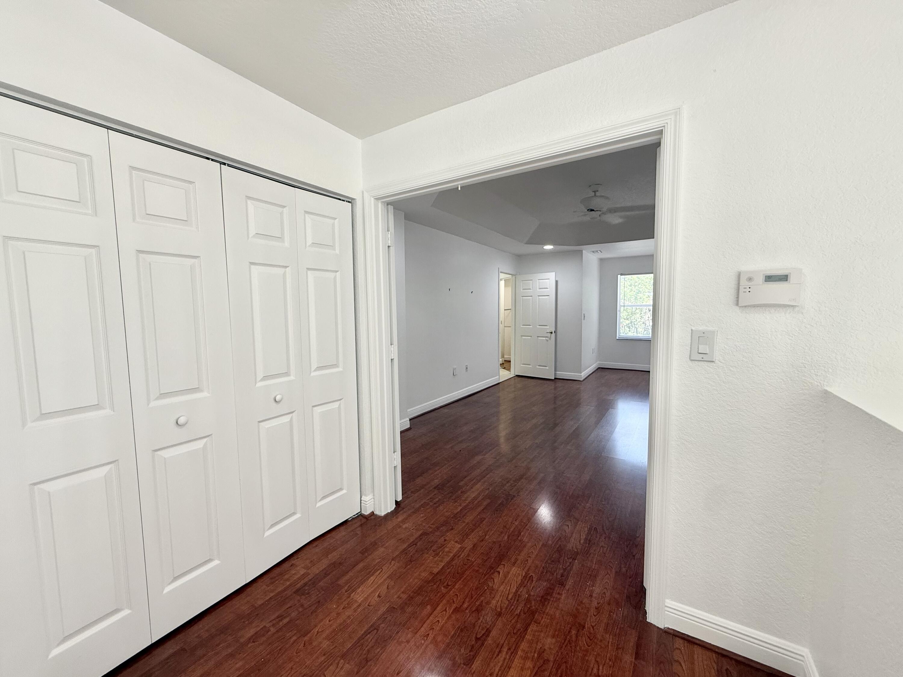 11553 Big Sky Court Boca Raton, FL 33498 - Photo 6 of 43 a view of a hallway with wooden floor