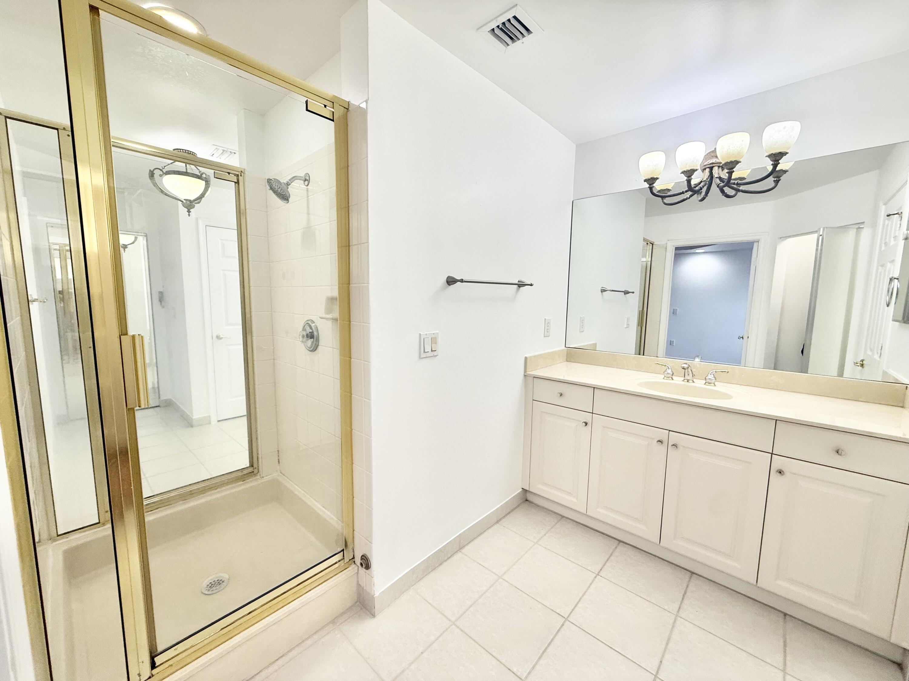 11553 Big Sky Court Boca Raton, FL 33498 - Photo 8 of 43 a bathroom with a double vanity sink mirror and shower