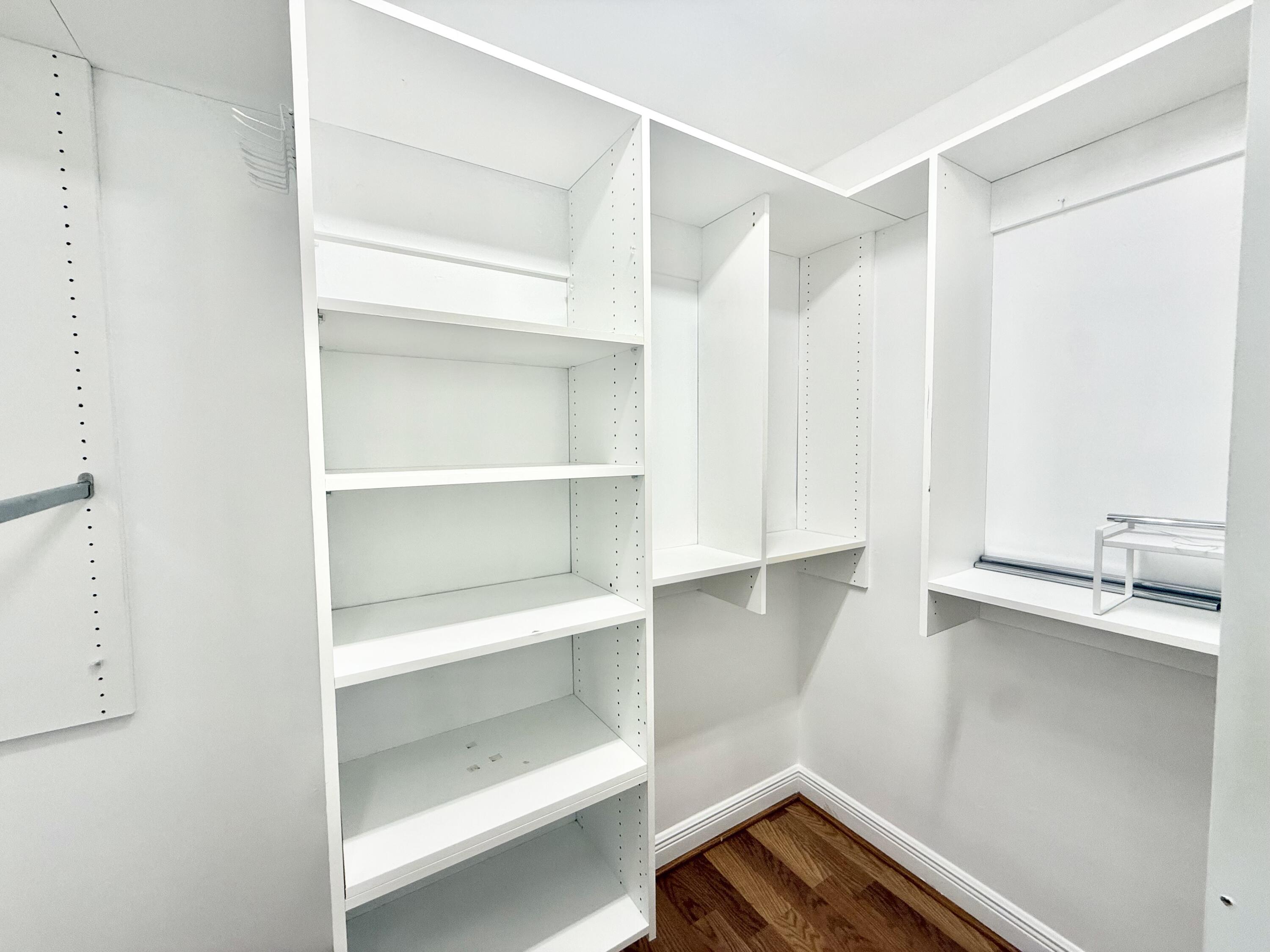 11553 Big Sky Court Boca Raton, FL 33498 - Photo 9 of 43 a room with a closet and wooden floor