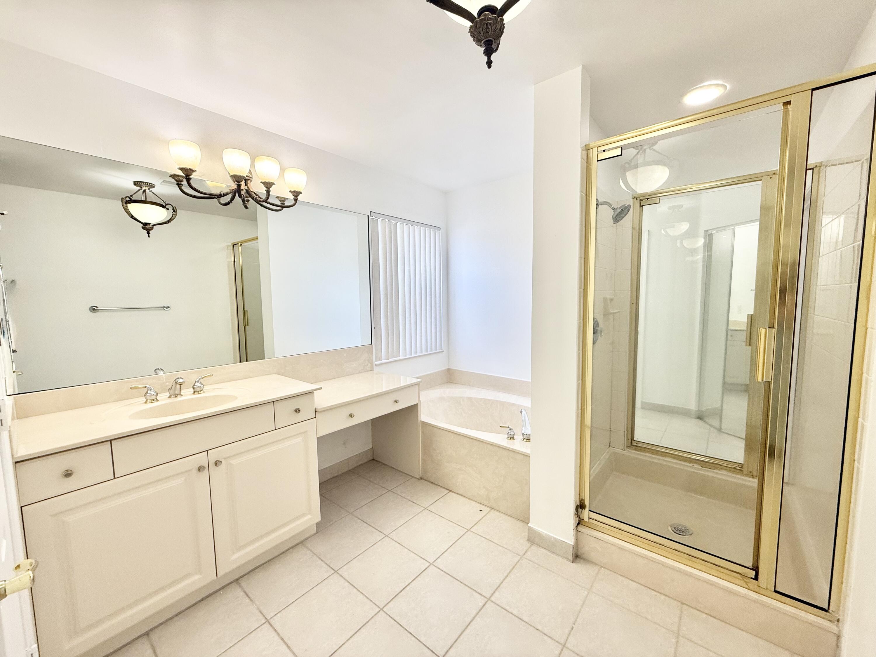 11553 Big Sky Court Boca Raton, FL 33498 - Photo 10 of 43 a bathroom with a granite countertop sink mirror and bathtub