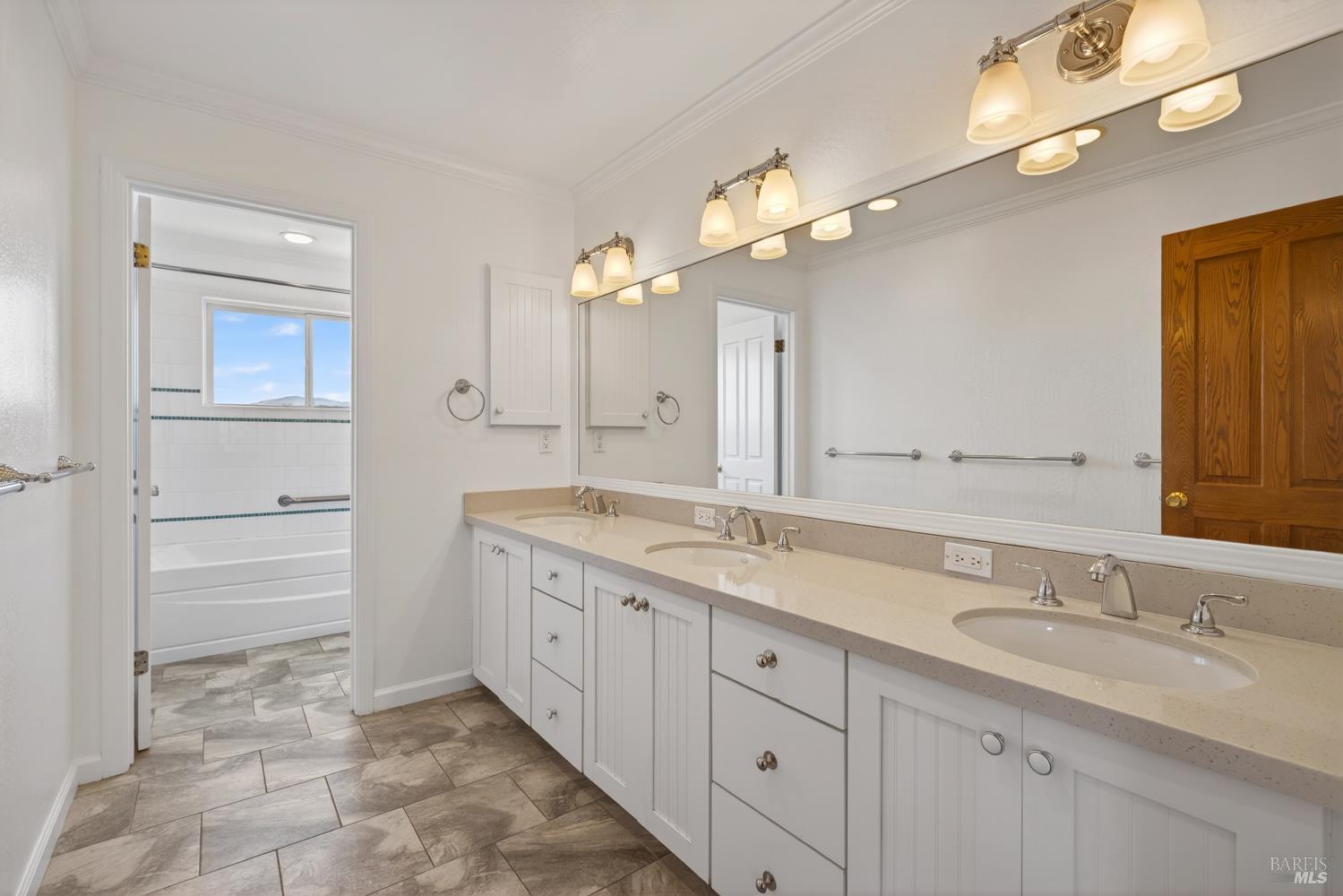 10 Lockton Lane Novato, CA 94945 - Photo 39 of 68 Large hall bathroom with triple vanity, separate shower, and private water closet, serving the upper-level bedrooms.