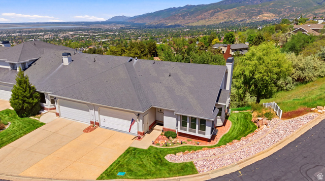 3766 Cardiff Circle Bountiful, UT 84010 - Photo 2 of 46 Expansive residential property featuring a multiple-car garage, mature landscaping, and a terraced rock garden along the street frontage