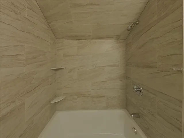 a view of a bathroom with toilet shower and a sink