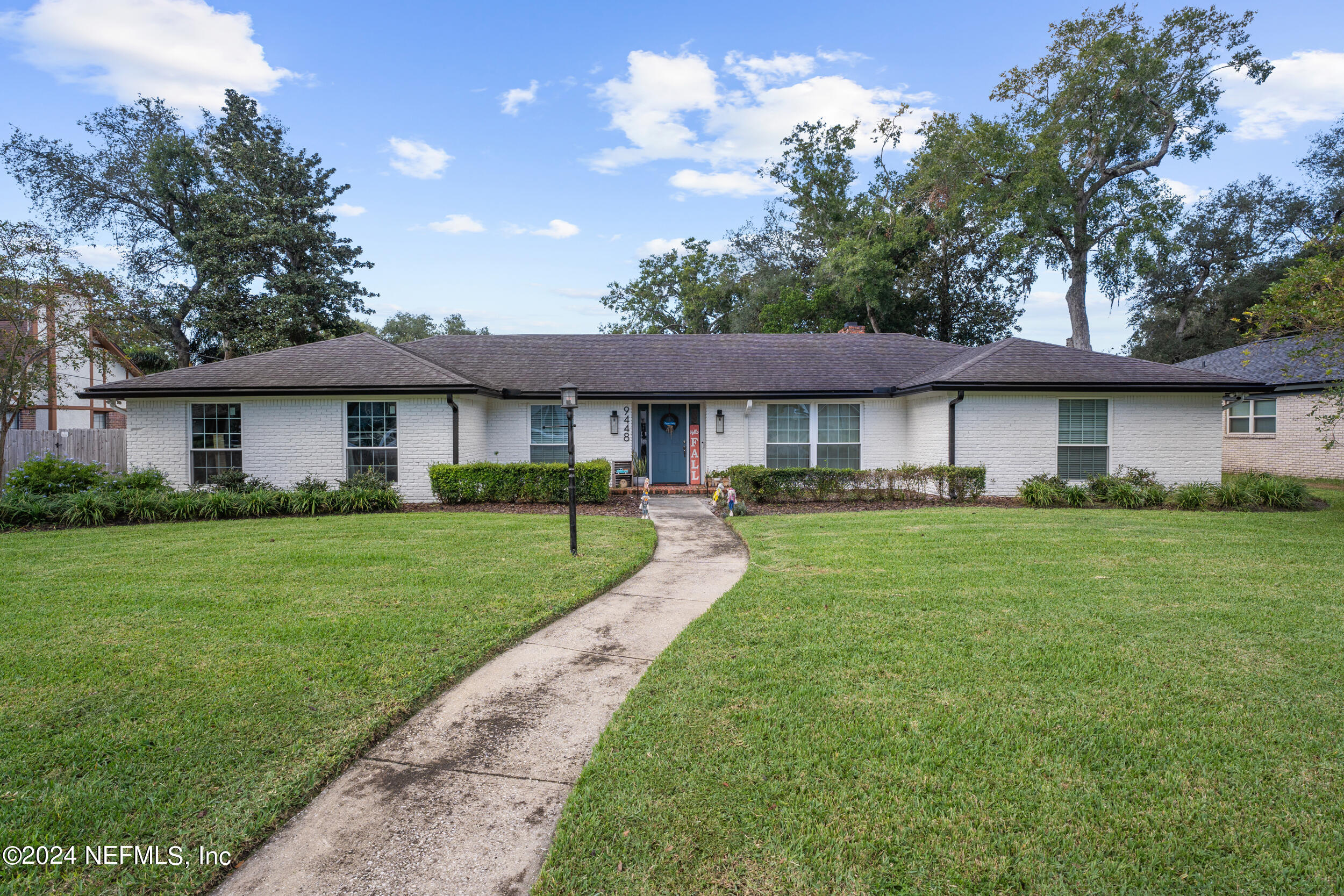 a front view of a house with a yard and porch