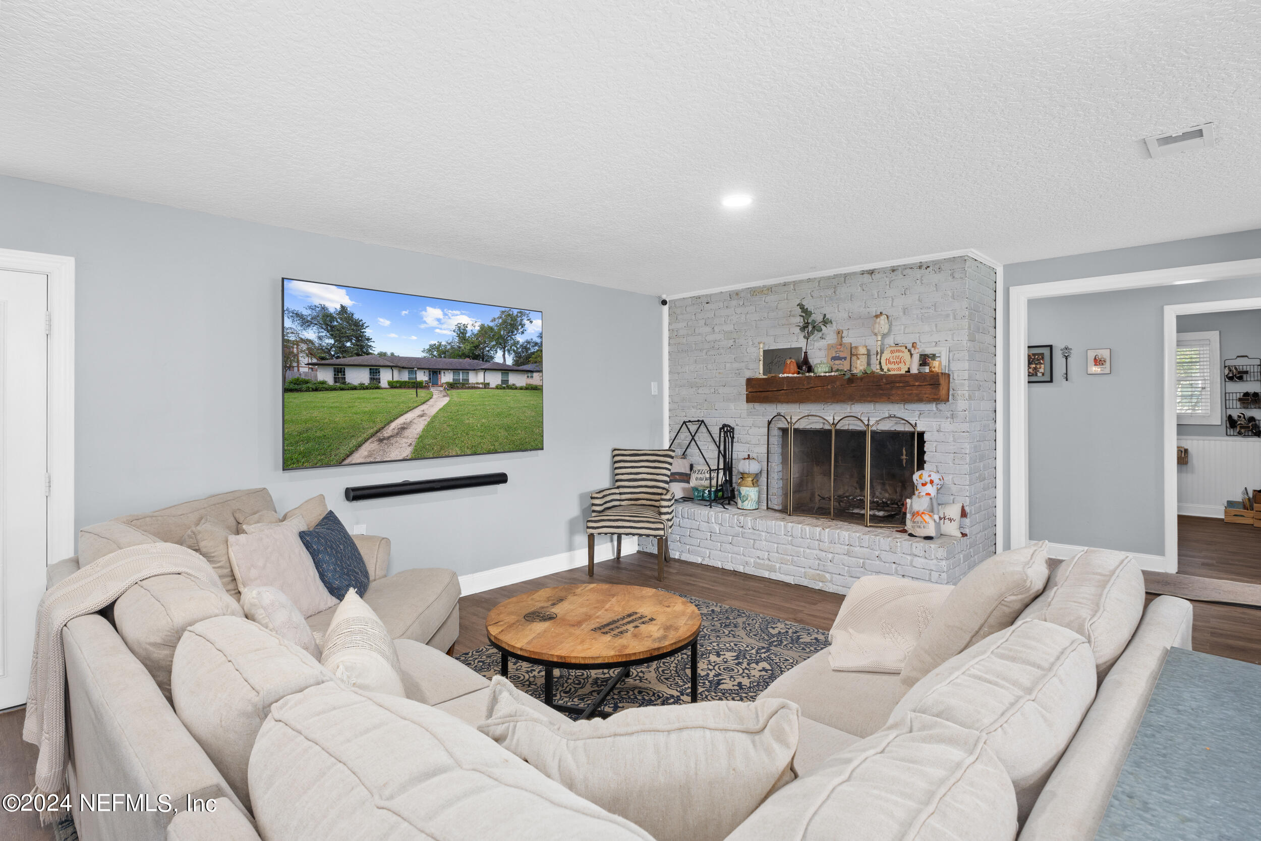 9448 Wexford Road Jacksonville, FL 32257 - Photo 11 of 27 a living room with furniture a flat screen tv and a fireplace