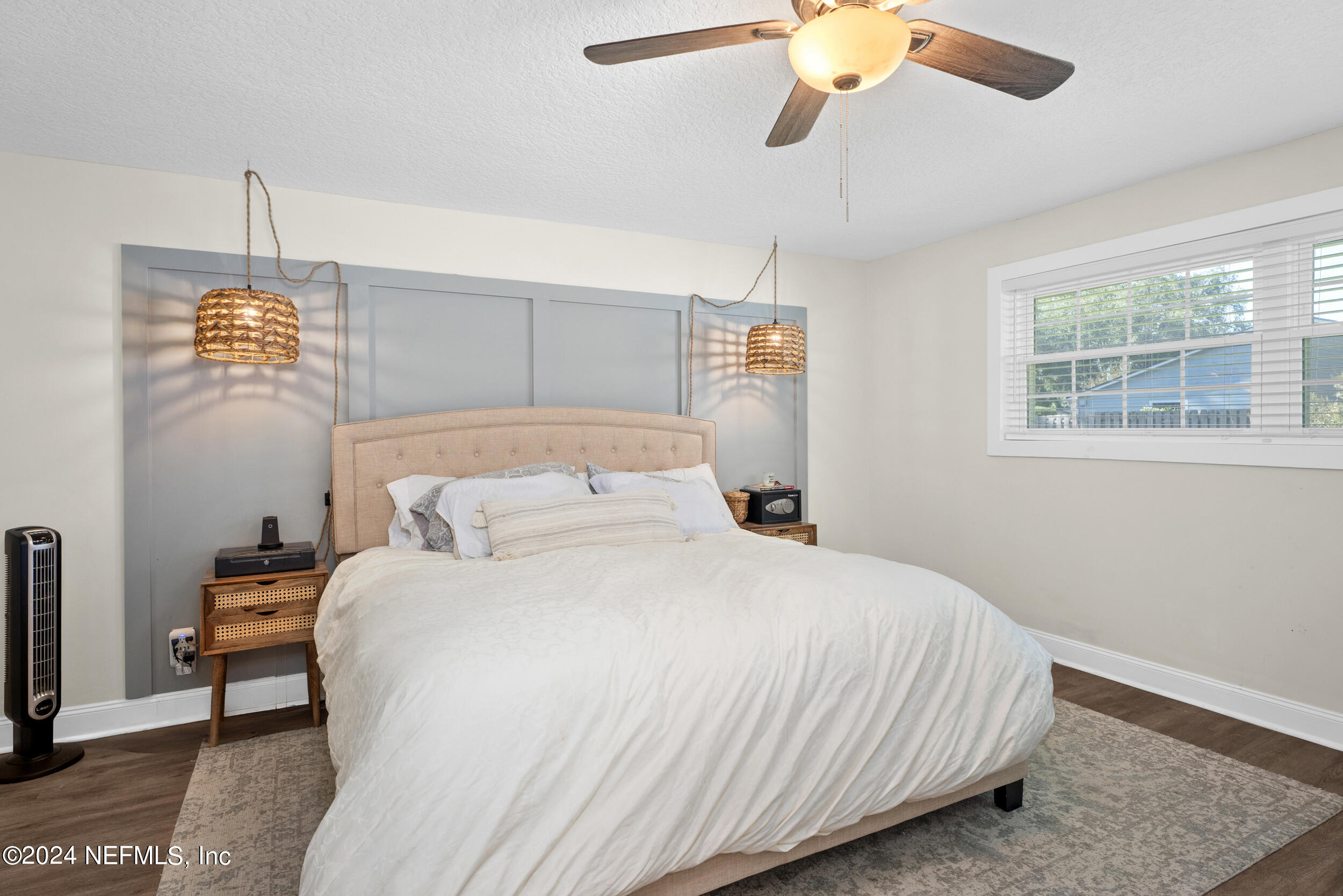 9448 Wexford Road Jacksonville, FL 32257 - Photo 16 of 27 a bedroom with a bed and a chandelier