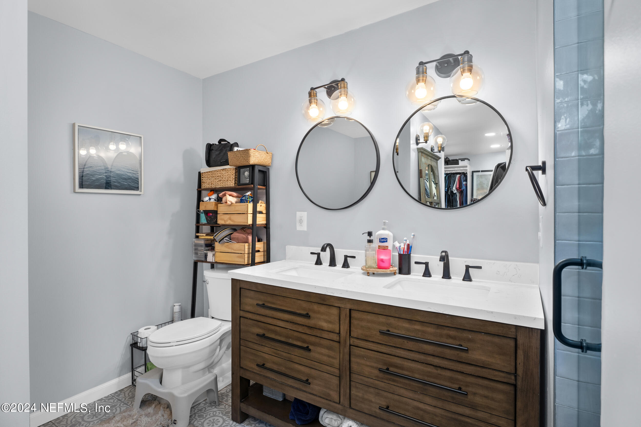 9448 Wexford Road Jacksonville, FL 32257 - Photo 17 of 27 a bathroom with a toilet a sink and a mirror