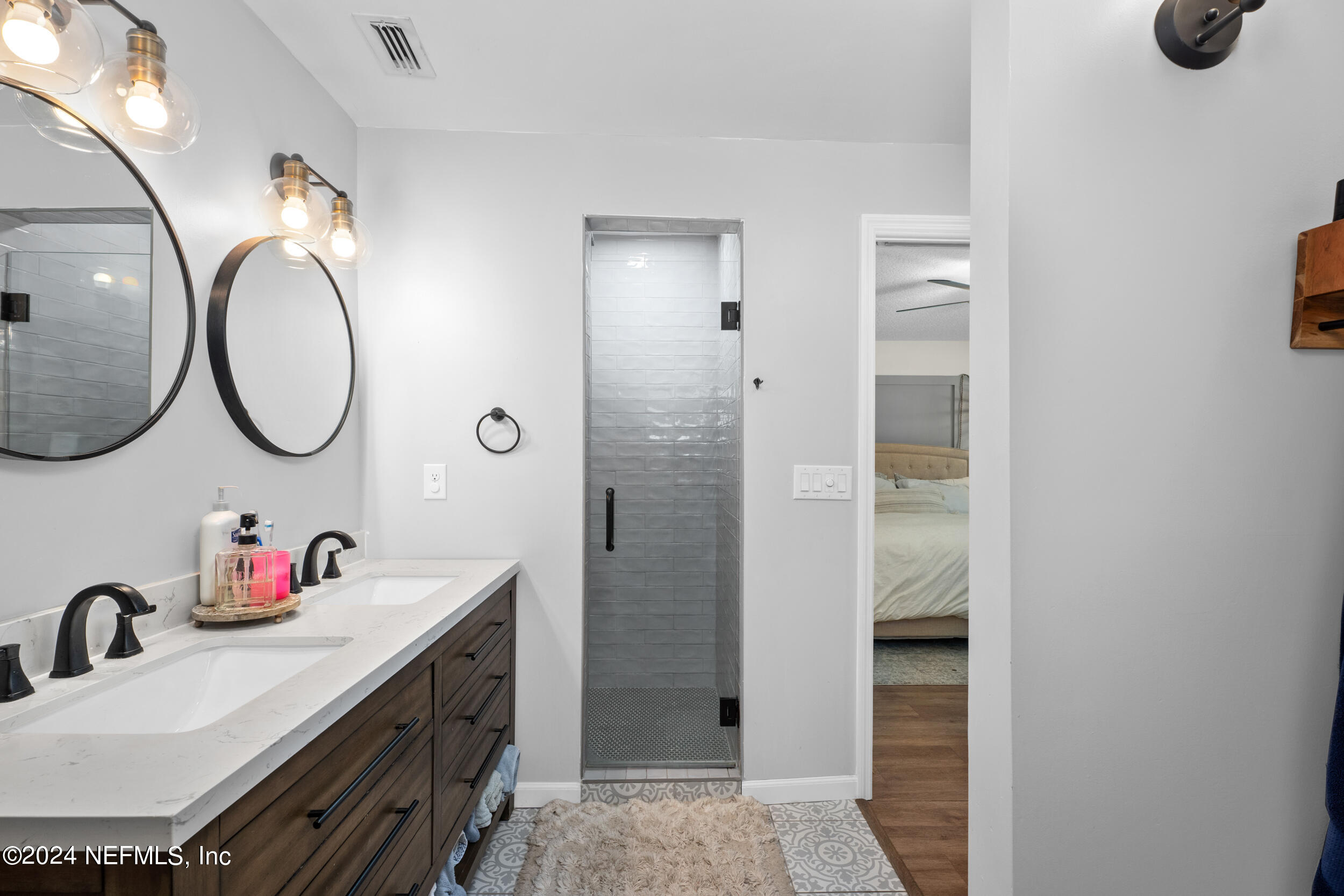 9448 Wexford Road Jacksonville, FL 32257 - Photo 18 of 27 a bathroom with a sink vanity and a mirror