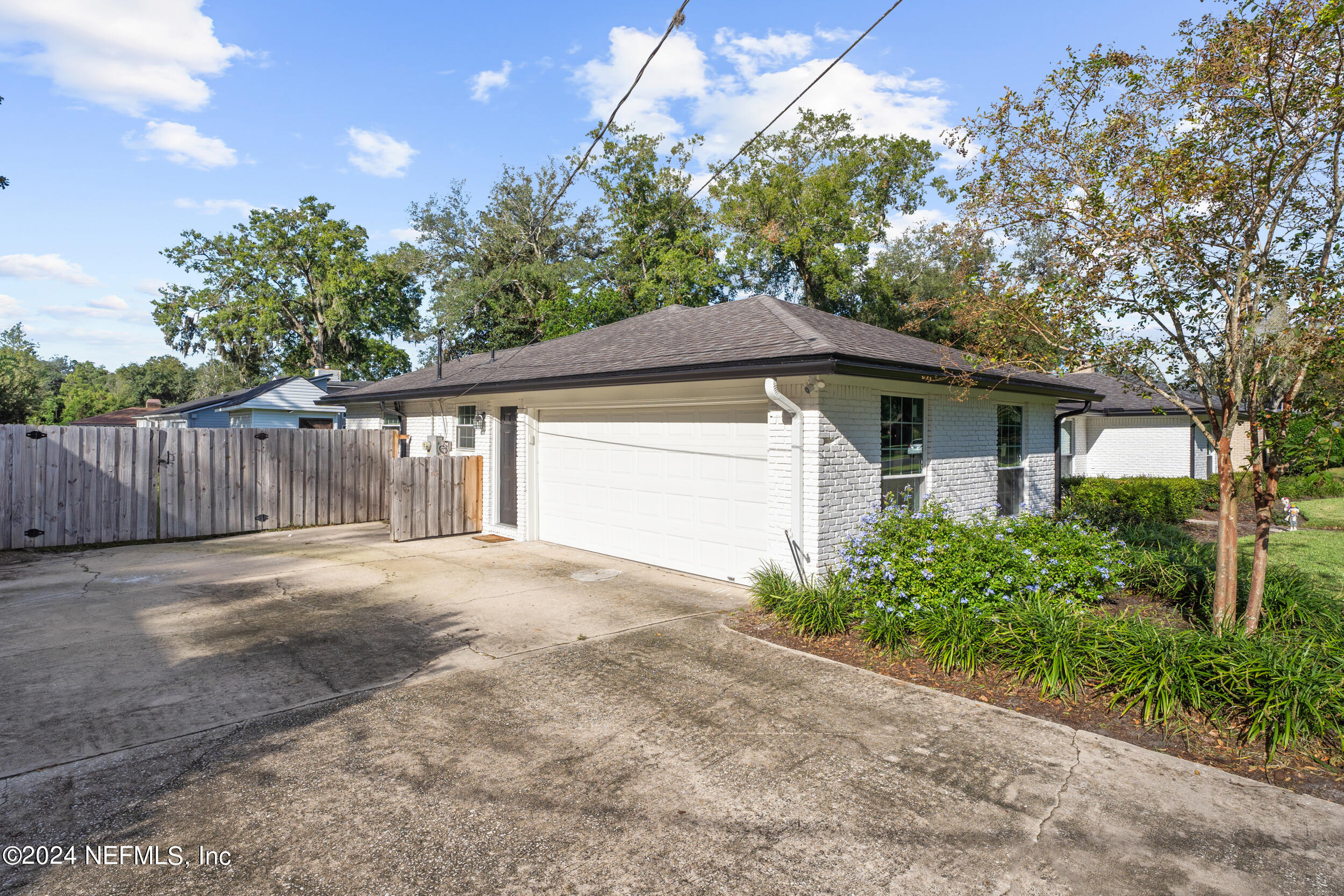 9448 Wexford Road Jacksonville, FL 32257 - Photo 3 of 27 a front view of a house with a yard and garage