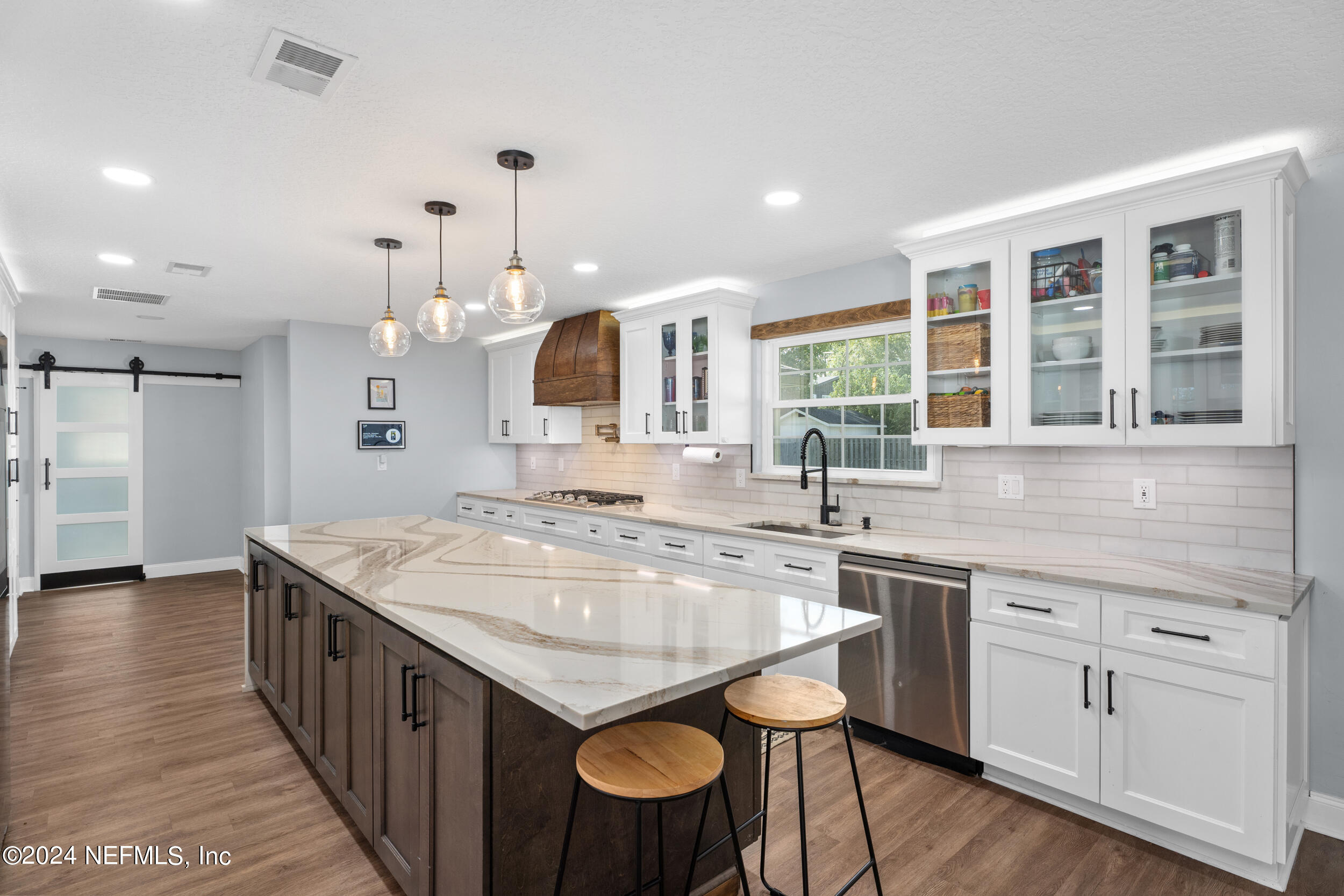 9448 Wexford Road Jacksonville, FL 32257 - Photo 7 of 27 a kitchen with counter top space sink and center island