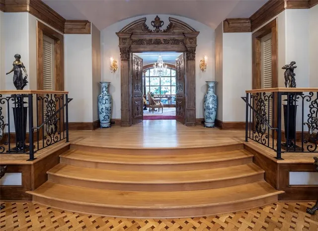 a view of entryway and hall with wooden floor