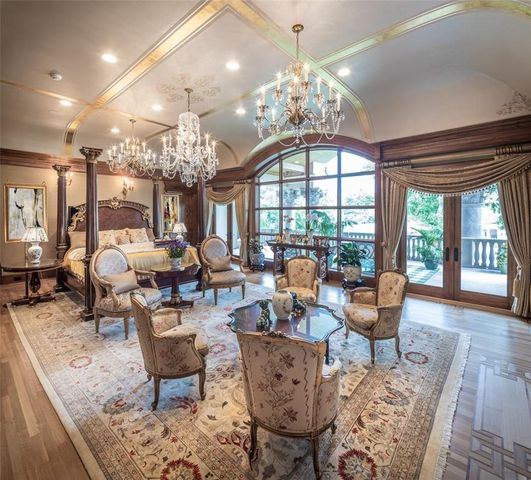 a living room with lots of furniture chandelier and a chandelier
