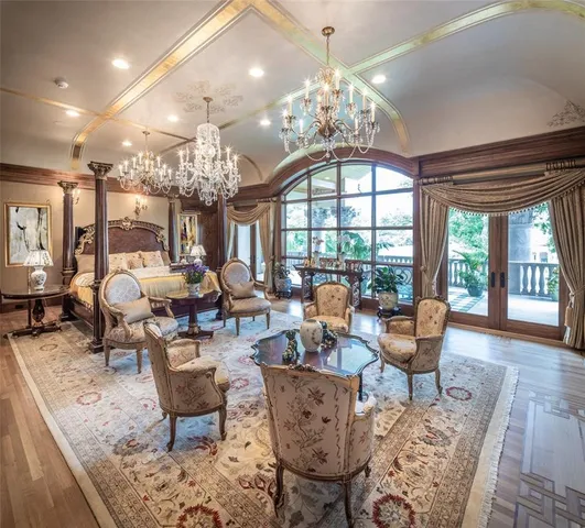 a living room with lots of furniture chandelier and a chandelier