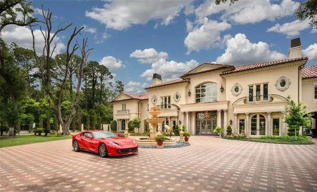 a front view of a house with cars parked